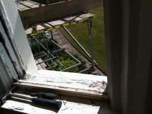 Sash window sill and frame requiring replacement.