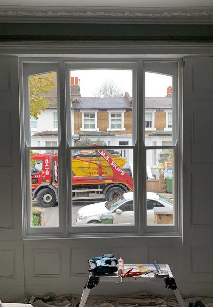 Internal look at a Venetian double glazed sash window with arched head fitted and touched in ready for the frame to be painted